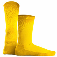 Football player showcasing agility while wearing Performance Grip Cleat Socks