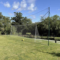 Rear view of Open Goaaal Regulation football goal showing backstop netting and rebounder system on a grass pitch